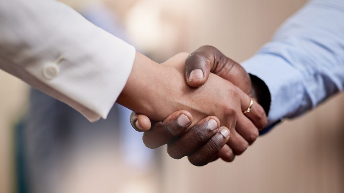 Welcome aboard the ship. Shot of two businesspeople shaking hands in greeting
