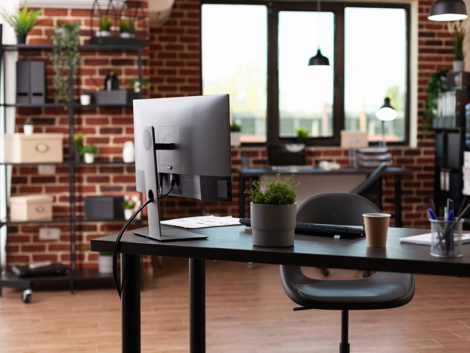 Nobody in business office with computer and instruments on desk.