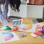 Young asian woman fashion designer working on her designs in the studio.